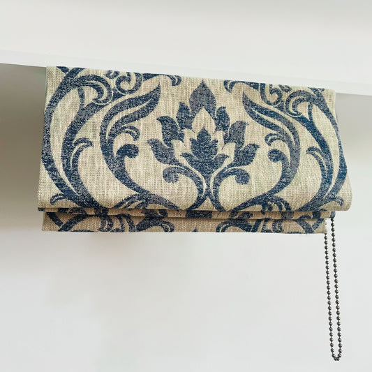 Small Roman blind made in Clarke & Clarke Leyburn Denim fabric, featuring a rich blue damask-style pattern and deluxe chain-operated headrail, made by Green Bee Interiors.