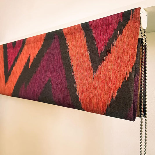 Hand-sewing blackout lining into a custom Roman blind using customer-supplied fabric.