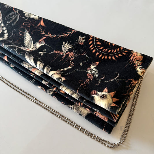 Handmade Roman blind in Clarke & Clarke Quetzal Velvet Charcoal. A bold velvet with exotic birds, luxe texture, blackout lining & deluxe chain headrail.