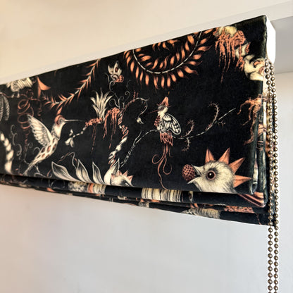 Decorative blind with bird and floral pattern on a plain background