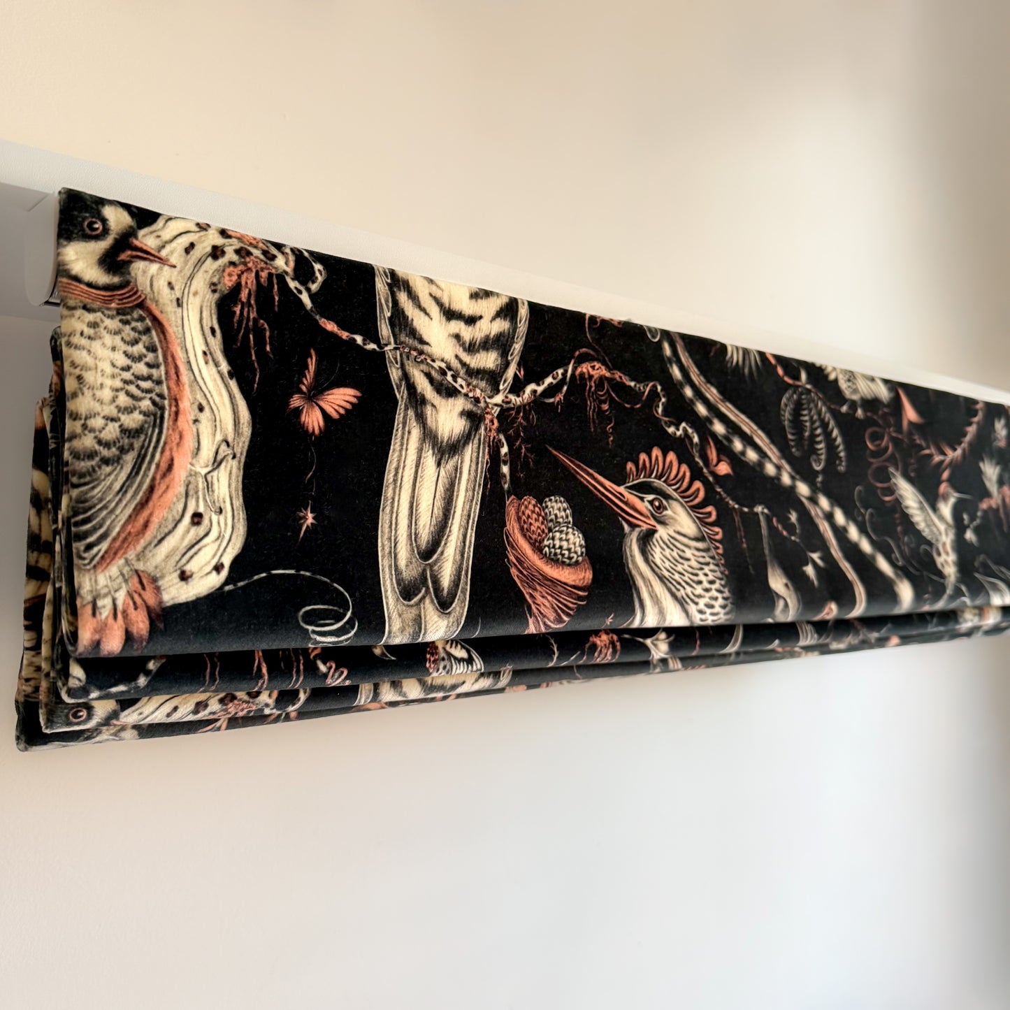Decorative blind with bird and nature pattern on a white background