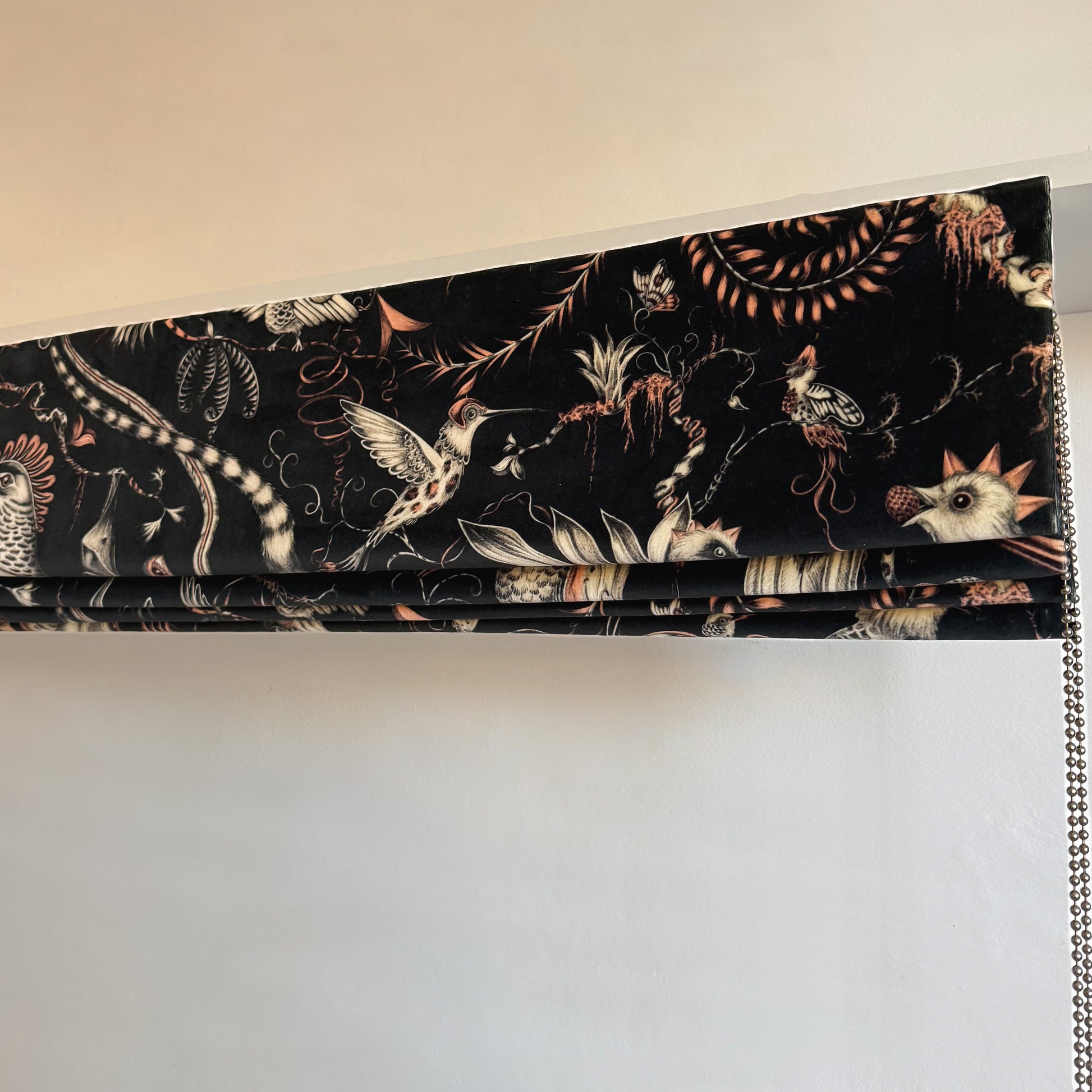 Window blind with animal pattern on a plain background