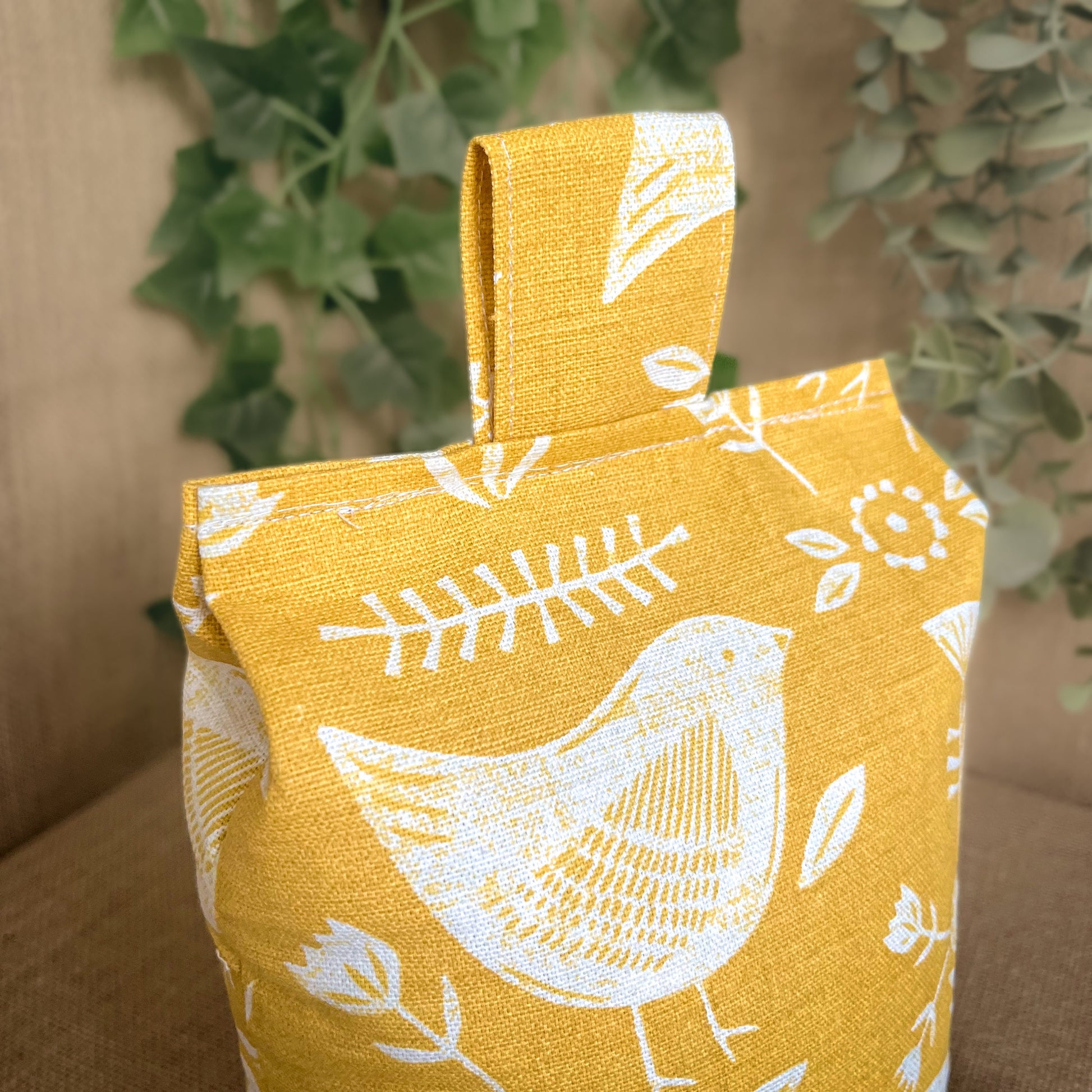 Handcrafted large yellow bird Scandinavian inspired wheat-filled door stop, crafted from high quality printed cotton. Measures 22cm tall x 15cm x 7cm at the base.