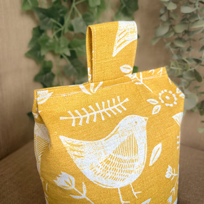 Handcrafted large yellow bird Scandinavian inspired wheat-filled door stop, crafted from high quality printed cotton. Measures 22cm tall x 15cm x 7cm at the base.