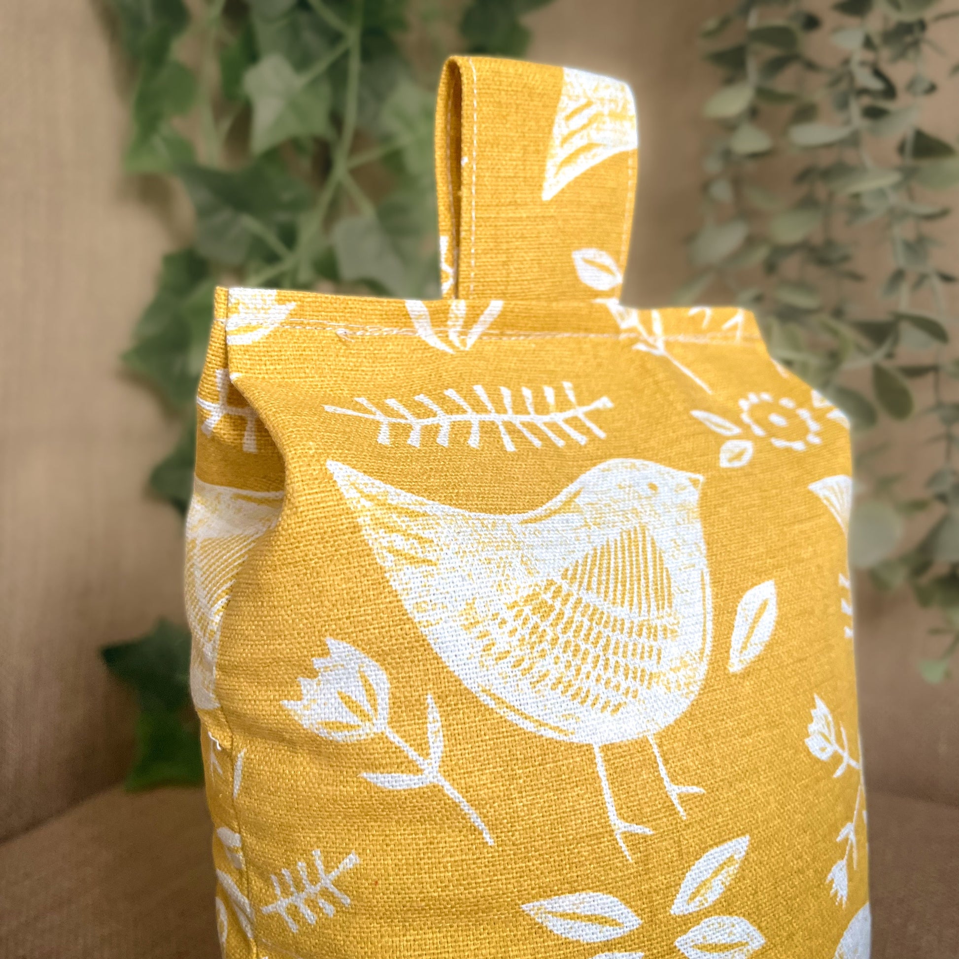 Handcrafted large yellow bird Scandinavian inspired wheat-filled door stop, crafted from high quality printed cotton. Measures 22cm tall x 15cm x 7cm at the base.