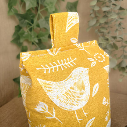 Handcrafted large yellow bird Scandinavian inspired wheat-filled door stop, crafted from high quality printed cotton. Measures 22cm tall x 15cm x 7cm at the base.