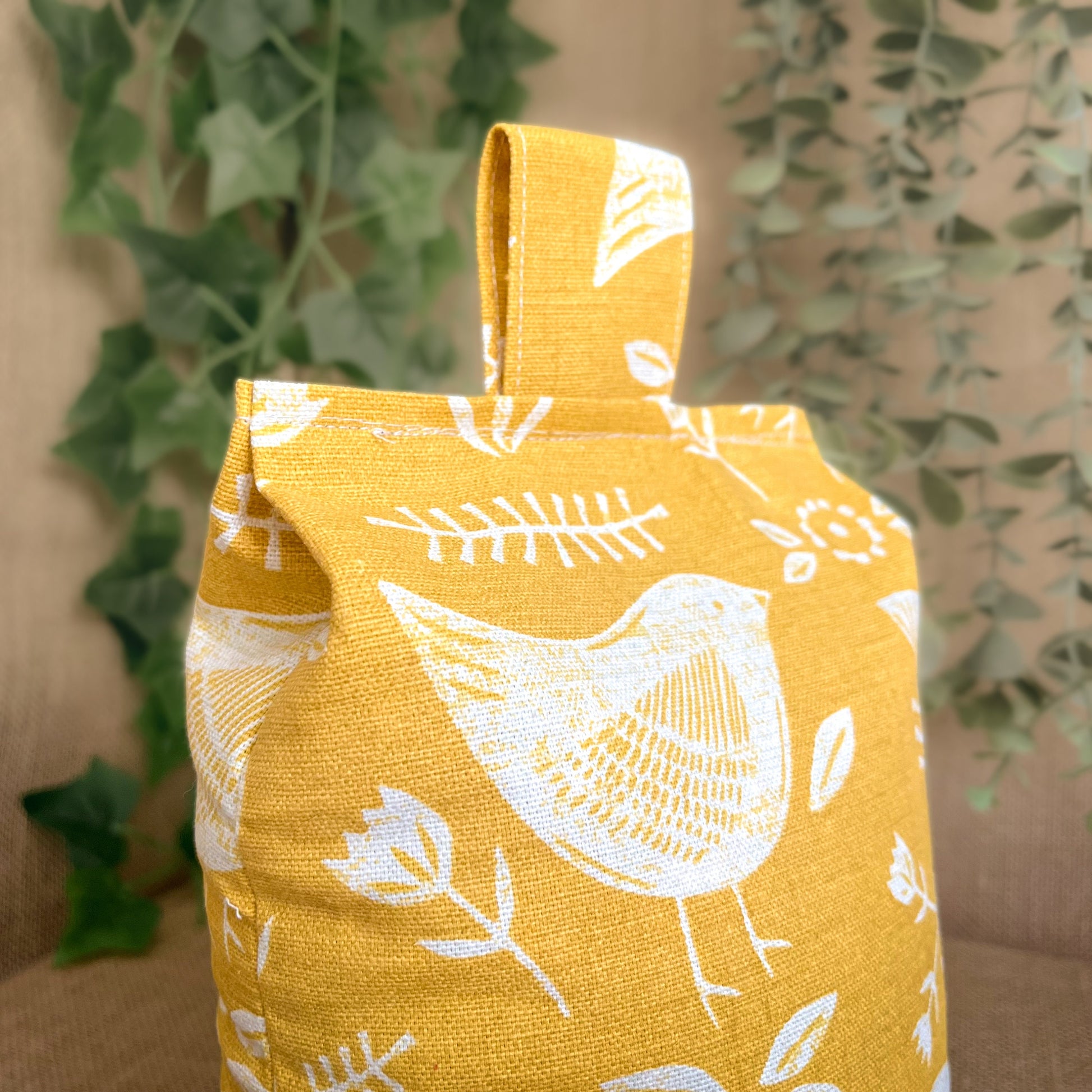 Handcrafted large yellow bird Scandinavian inspired wheat-filled door stop, crafted from high quality printed cotton. Measures 22cm tall x 15cm x 7cm at the base.