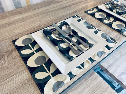 Orla Kiely grey oval table linen set including napkins, placemats, and table runners. Each piece features a sophisticated oval pattern in grey, adding a touch of modern elegance to your dining table. Perfect for creating a cohesive and stylish table setting.